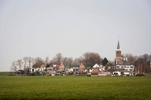Small village with a church and some houses in the Netherlands