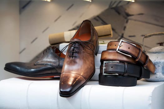 Leather men shoes and belts in the shoe store