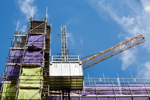 Scaffolding with protection nets on a construction site