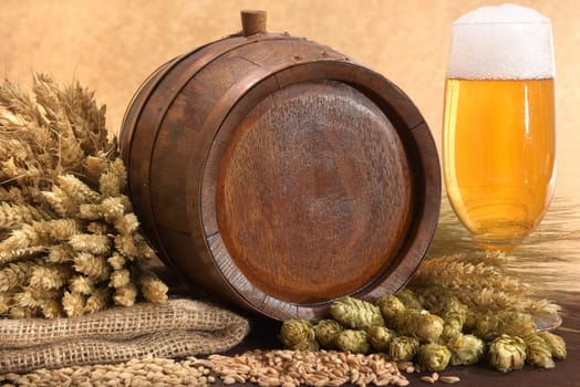 Old wooden barrel with beer glass,wheat,barley,hops and malt