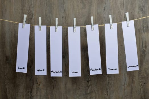 seven sheets of paper hanging on a clothesline