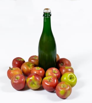 bottle of cider with apples on the white background