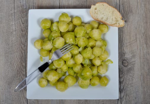 plate of brussels sprouts on the wood table
