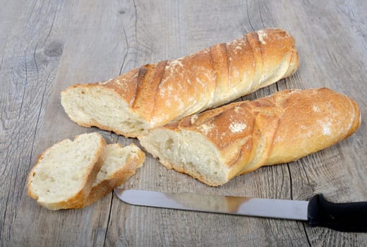..cut french bread sliced on a wooden table