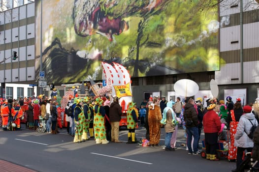 Cologne,Germany – March 02,2014: Colourfully dressed people wearing masks and costumes await the carnival procession on March 2,2014 in Cologne.