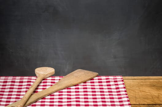 Kitchen utensils in front of black wall panel