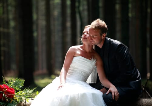 bride and groom shooting at the wedding in the forest