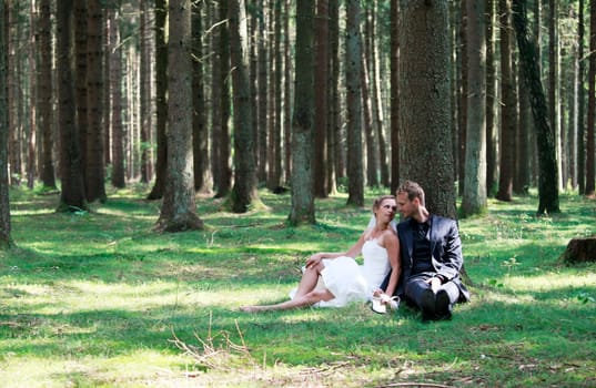 bride and groom shooting at the wedding in the forest
