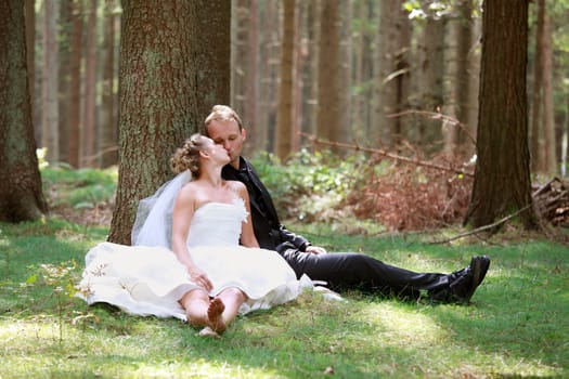 bride and groom shooting at the wedding in the forest