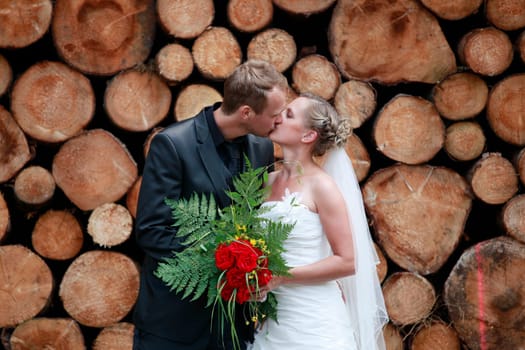 bride and groom shooting at the wedding in the forest