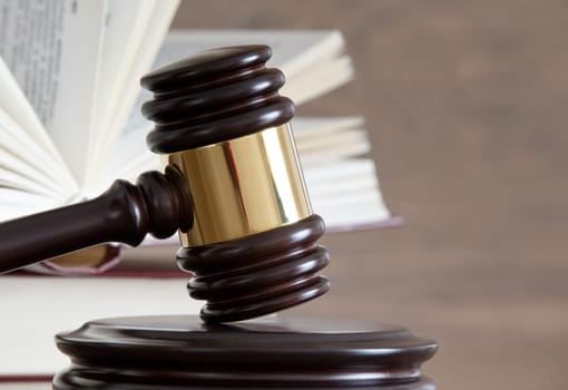 wooden gavel and books on wooden table