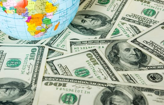 A globe and dollars is isolated on a whiteness