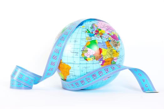Measuring tape stretched across globe on white