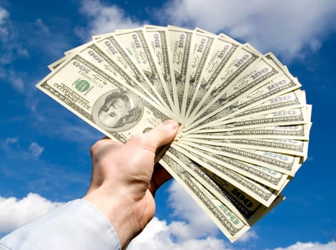 Money in hand  isolated on sky background