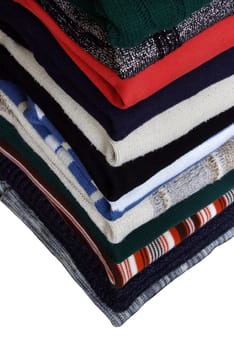 Heap of sweaters of clothes on a whiteness