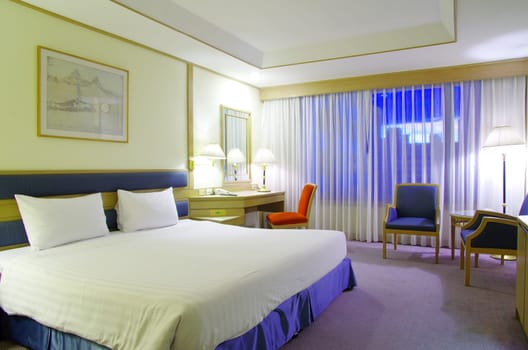 Luxurious hotel room interior with bed