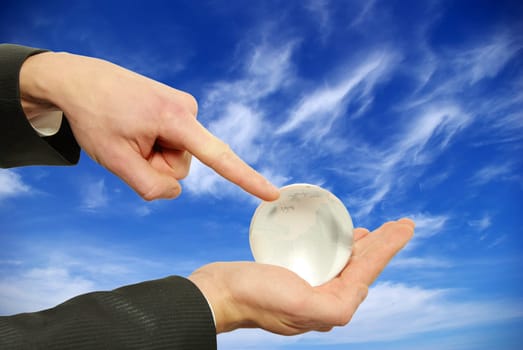globe in hand isplated on sky