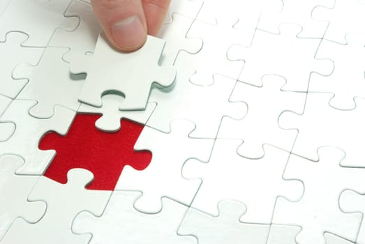 hands holding a puzzle piece . business concepts
