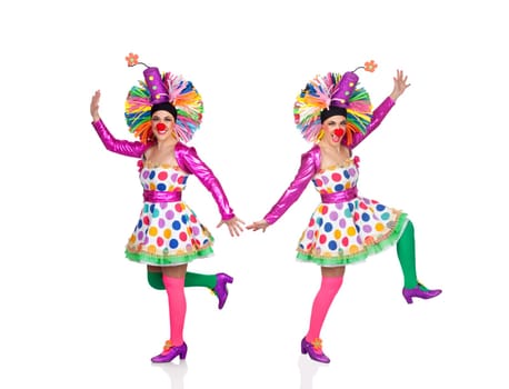Two funny clowns dancing isolated on a white background