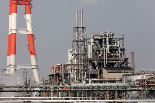 Industrial refinery plant with smokestack