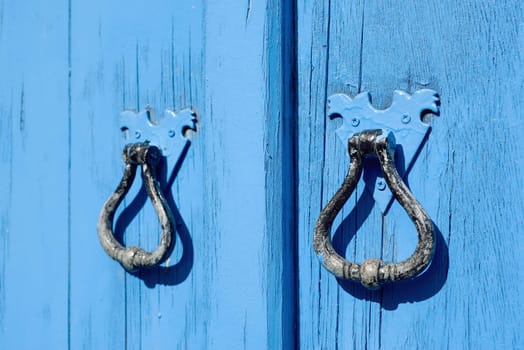 Old blue wooden door with round handles