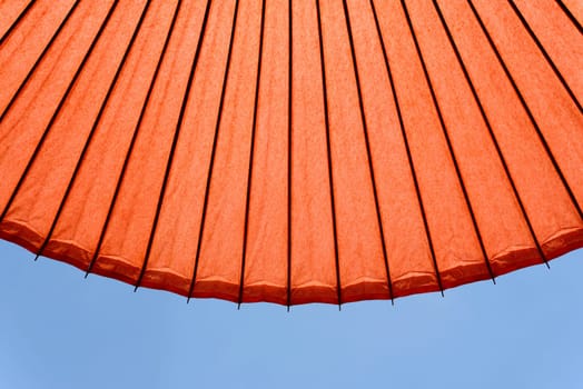 Japanese red umbrella against clear blue sky