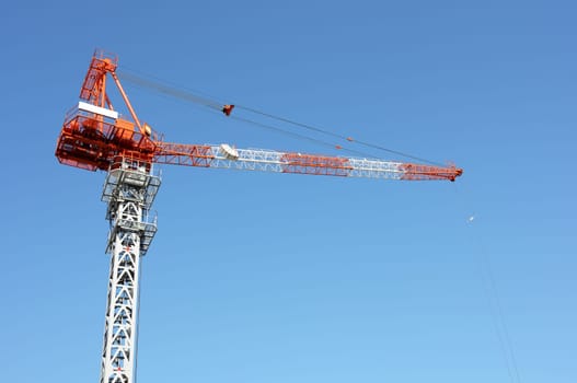 Crane boom against a clear blue sky