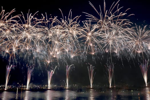 fireworks reflect on sea water