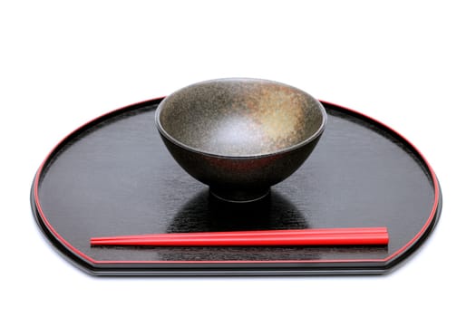 rice bowl and chopsticks on wooden tray