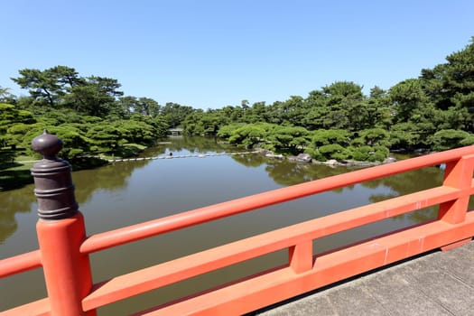 Japanese garden with red wooden bridge