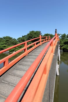 Red wooden bridge in the Japanese park