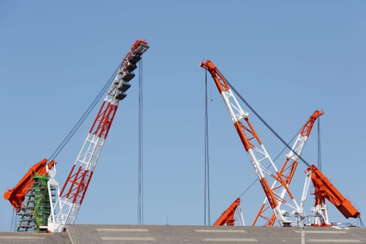 Building crane boom against a clear blue sky
