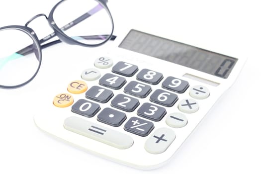 Calculator with eyeglasses isolated on white background, stock photo