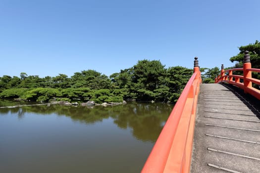 Japanese garden with red wooden bridge