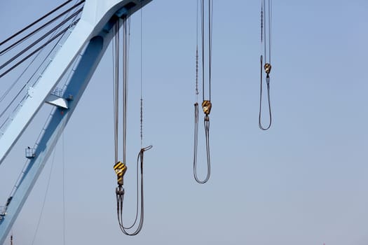 Crane boom against a clear blue sky