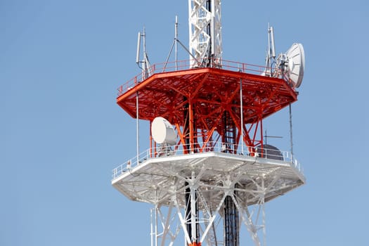 View of communications tower against blue sky