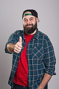 young bearded man with baseball cap with thumb up