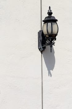Old lamp lantern on the white wall