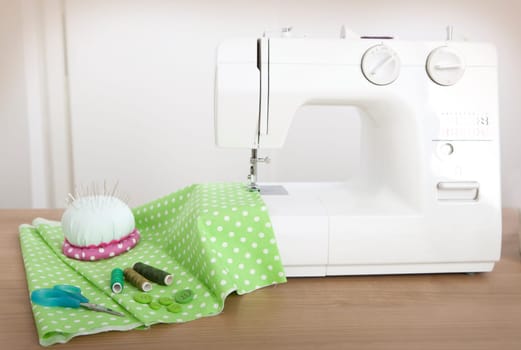 with a sewing machine a green cloth is sewn over