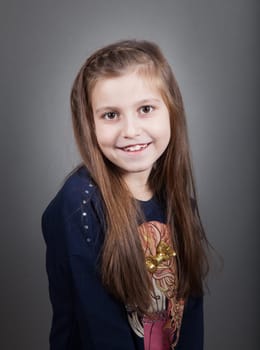Portrait of a 8 year old girl, nicely dressed, studio shot.
