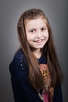 Portrait of a 8 year old girl, nicely dressed, studio shot.
