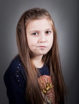 Portrait of a 8 year old girl, nicely dressed, studio shot.