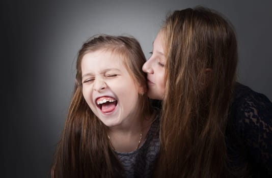 Portrait of8 and 10 year old sisters, studio shot.