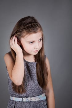 Portrait of a 8 year old girl, nicely dressed, studio shot.