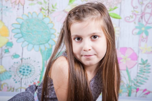 Portrait of a 8 year old girl, nicely dressed, studio shot.