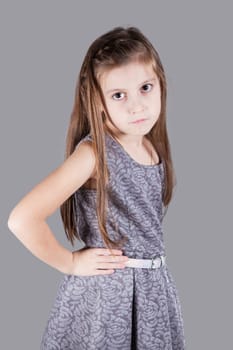 Portrait of a 8 year old girl, nicely dressed, studio shot.
