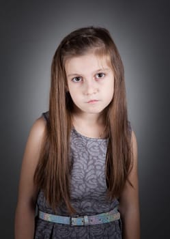 Portrait of a 8 year old girl, nicely dressed, studio shot.