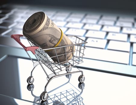 A roll of dollar bills in a shopping cart over a laptop keyboard.