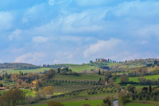 Typical Tuscan countryside with cypresses and farmhouses