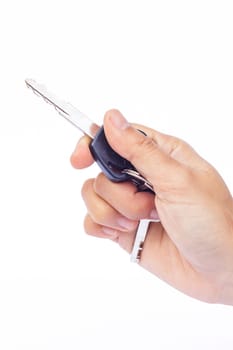 Hand with a car key isolated on white background, stock photo